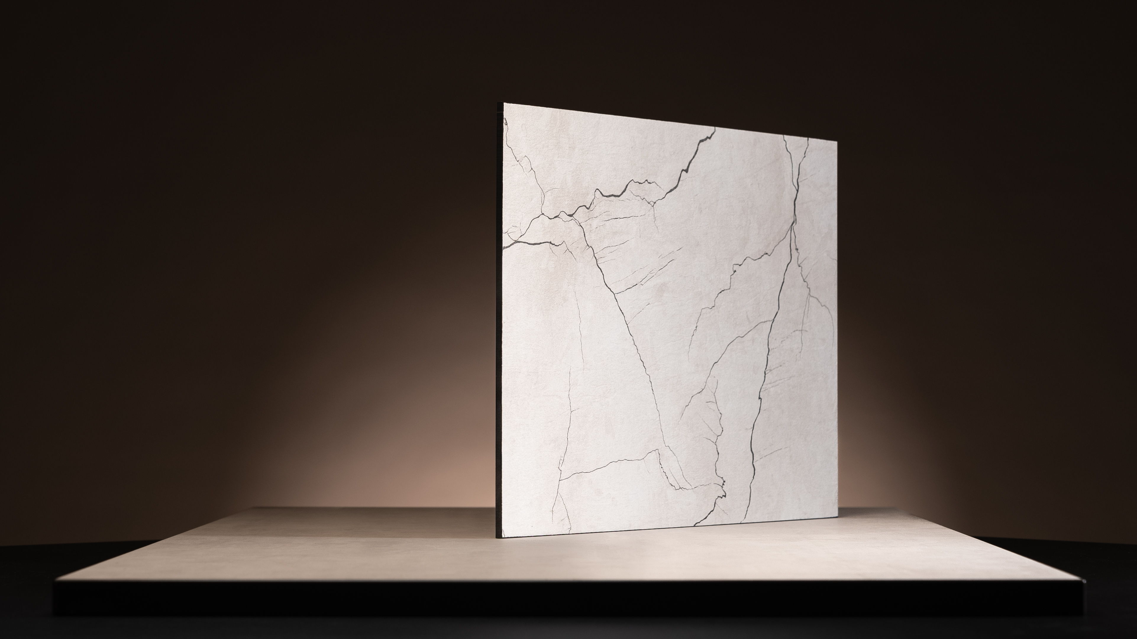 Kompaktlaminat til indendørs brug, med en sort kerne og en overflade i et sort og hvidt mønster.